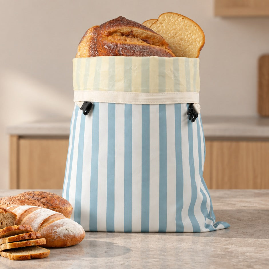 Bread bag on a stone kitchen counter beside sliced bread