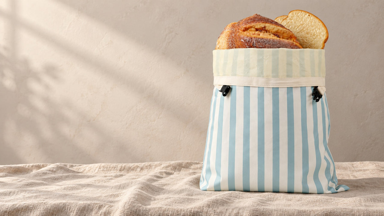 Striped bread bag standing on a linen tablecloth
